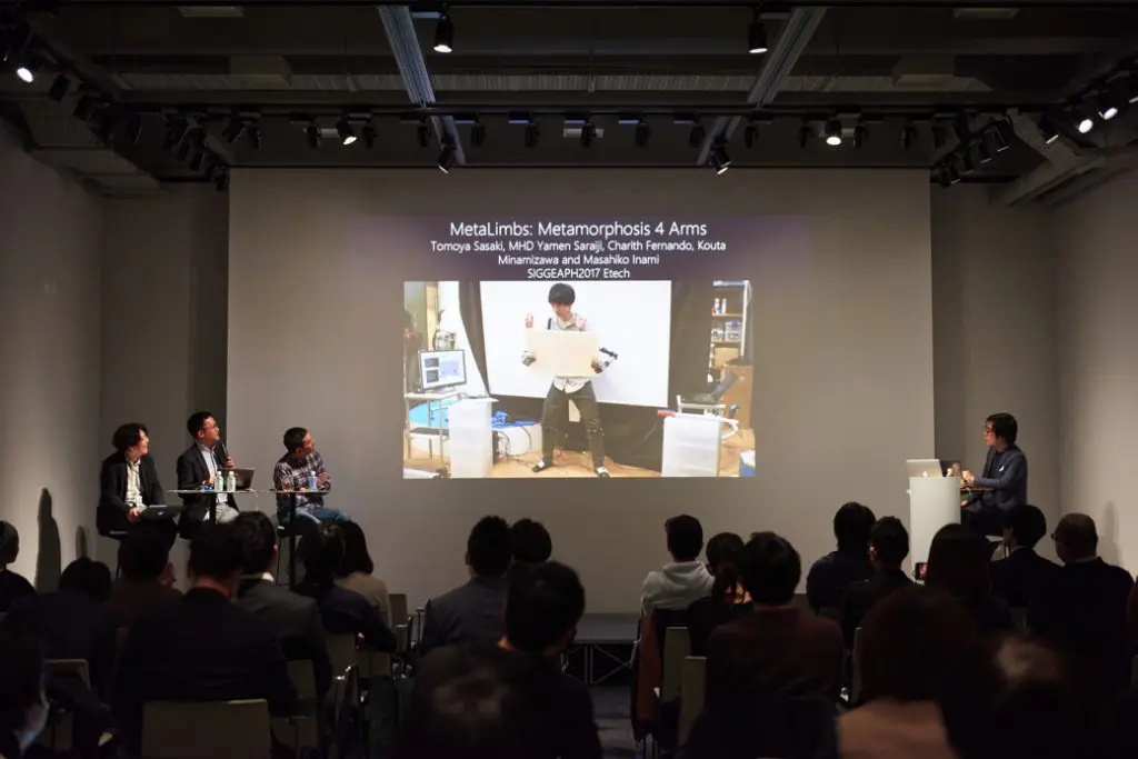 ２本のロボットハンドを着けて人間の腕を４本にする「メタリム」